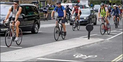  ??  ?? Prefer the main roads: Cyclists ignore the new lanes and join moving traffic around Westminste­r