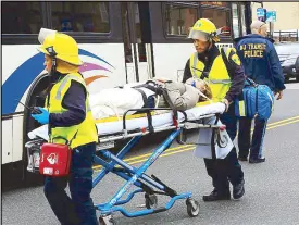  ?? AFP ?? An injured woman is evacuated at New Jersey Transit’s rail station in Hoboken Thursday.