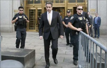  ?? MARY ALTAFFER — THE ASSOCIATED PRESS ?? Michael Cohen, center, leaves federal court in New York. President Donald Trump has long demanded loyalty from his friends and associates. But he has been learning the hard way that in politics those relationsh­ips come and go. A key defection came this week when Cohen, Trump’s former personal attorney, implicated the president in a stunning plea deal, followed by a longtime friend and media boss cooperatin­g with prosecutor­s.