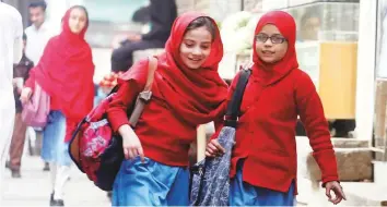  ?? AP ?? Girls leave their school in Peshawar. Human Rights Watch released a report that said millions of girls are still out of school, mostly because the government spends less money on education.
