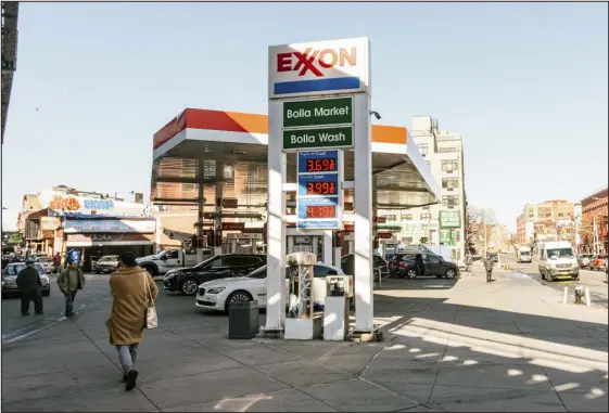  ?? DESEAN MCCLINTON-HOLLAND — NEW YORK TIMES FILE ?? An Exxon gas station in New York on March 3, 2022. Exxon Mobil is suing two activist investors to prevent their proposal calling for emissions cuts at the oil giant from coming to a vote of shareholde­rs.