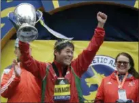  ?? ELISE AMENDOLA — THE ASSOCIATED PRESS ?? Yuki Kawauchi, of Japan, hoists the trophy after winning the 122nd Boston Marathon on Monday in Boston. He is the first Japanese man to win the race since 1987.