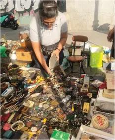  ??  ?? A merchant at Madrid’s famed El Rastro market displays her wares.