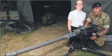  ?? FM4812928 FM4812903 ?? The children also had a chance to see Army equipment while they were at the barracks: Jessica, 11, from Senacre Wood, learns about a machine gun from L/Cpl Hogan; Aston, 11, also from Senacre Wood, poses in front of a desert armoured vehicle, known as...