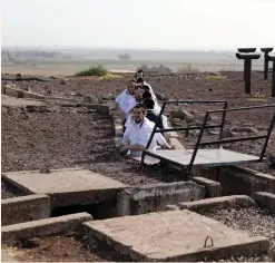  ?? (Ammar Awad/Reuters) ?? ULTRA-ORTHODOX JEWS take cover on the Golan Heights yesterday.