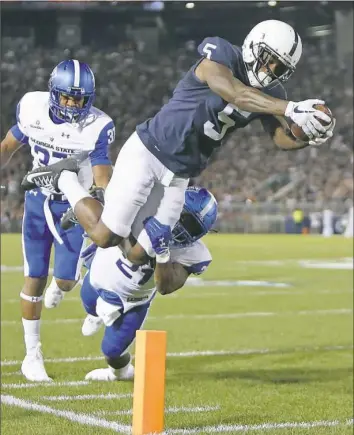  ?? Justin K. Aller/Getty Images ?? DaeSean Hamilton dives for the end zone to finish a 27-yard scoring pass and run in the first half of Penn State’s rout of Georgia State Saturday night at in University Park, Pa.