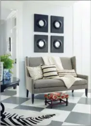  ?? BURNHAM DESIGN, COASTAL LIVING, TRIA GIOVAN ?? This is the entry of a home in Coronodo, Calif. Crisp, light colors dominate this room designed by Burnham Design, and are set off by the strategic use of contrastin­g black accents in the table and throw pillows, and the black table.