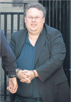  ??  ?? Disgraced businessma­n Stuart Newing-Davis is led away to begin his sentence for VAT fraud.