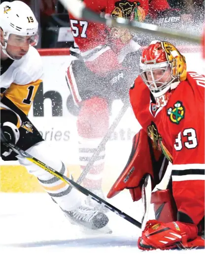  ??  ?? Goalie Scott Darling stops Penguins forward Garrett Wilson for one of his 33 saves in the Hawks’ preseason opener. | NAM Y. HUH/ AP