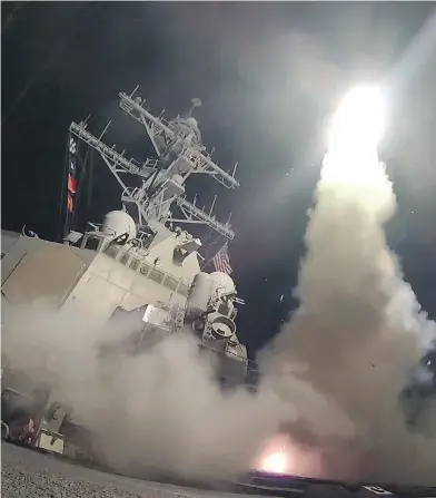  ?? FORD WILLIAMS / U.S. NAVY VIA GETTY IMAGES ?? The guided-missile destroyer USS Porter fires a Tomahawk land attack missile on Friday in the Mediterran­ean Sea.