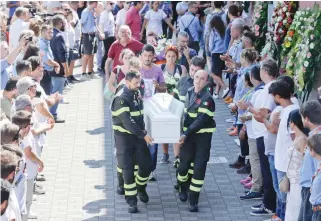  ??  ?? HEART-BREAKING: The coffin of 9-year-old Giulia Rinaldo, is carried outside the gymnasium at the end of the state funeral service in Ascoli Piceno, Italy, Saturday. Funerals for some victims took place on Friday, while those for many others are...