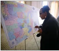  ?? (Arkansas Democrat-Gazette/Thomas Metthe) ?? Dianne Curry, president of the Little Rock NAACP branch, looks at district maps for the Arkansas House of Representa­tives after Monday’s Board of Apportionm­ent meeting at the state Capitol in Little Rock.
