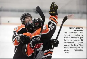  ?? NEWS PHOTO RYAN MCCRACKEN ?? The Medicine Hat Hounds celebrate Jesse Klimosko’s goal during a peewee AA tournament game against the Bow River Bruins on Friday at the Moose Recreation Centre.