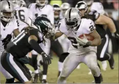  ?? PHOTO/MICHAEL PEREZ ?? This Monday file photo shows Oakland Raiders’ Marshawn Lynch (24) running against Philadelph­ia Eagles’ Ronald Darby (41) during the second half of an NFL football game in Philadelph­ia. Lynch has money on the line in the season finale. AP