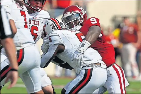  ??  ?? Oklahoma linebacker Kenneth Murray tackles Texas Tech running back Armand Shyne on Sept. 28 in Norman, Okla.