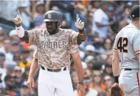  ?? Kyusung Gong / Associated Press ?? The Padres’ Jose Pirela celebrates his two-run triple as Giants third baseman Evan Longoria looks away in the seventh inning. San Diego won the final three games of the four-game series.