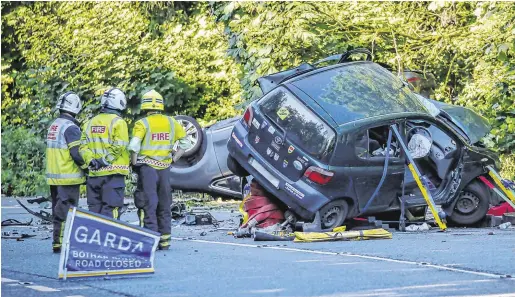  ??  ?? Wreckage:
Firefighte­rrs at the scene of the accident. PHOTO: CRISPIN RODWELL