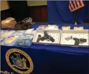  ?? RECORD FILE PHOTO ?? State police display weapons, drugs and other illegal items seized during raids in August 2015 that targeted members of the Young Gunnerz, a violent Troy drug gang.