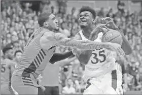  ?? Associated Press ?? Physical play: In this Nov. 27, 2019, file photo, Dayton forward Obi Toppin (1) knocks the ball away from Kansas center Udoka Azubuike (35) during the first half of an NCAA college basketball game in Lahaina, Hawaii. Kansas and Dayton were headed toward earning No. 1 seeds in the NCAA tournament, so any meeting would have to be in the Final Four or national championsh­ip game. What a rematch it would be. The Jayhawks and Flyers played a high-level game at the Maui Invitation­al, won 90-84 in overtime by Kansas.