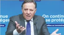  ?? PAUL CHIASSON/THE CANADIAN PRESS ?? Premier François Legault thanked Quebecers on Tuesday for reducing contacts and respecting the curfew, saying: “the efforts you are making are starting to pay off.”