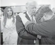  ?? Jae C. Hong / Associated Press ?? Donald Trump, center, prays with pastor Joshua Nink, after a Sunday service at First Christian Church, in Council Bluffs, Iowa, in January.