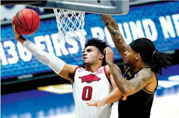  ?? Associated Press ?? ■ Arkansas' Justin Smith drives against Missouri's Mitchell Smith, right, Friday during the first half of the Southeaste­rn Conference Tournament in Nashville, Tenn.