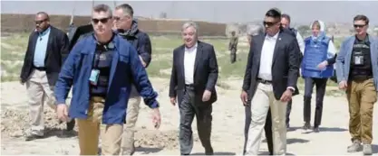  ??  ?? KABUL: UN Secretary General Antonio Guterres (center) arrives to meet Afghan families who fled the conflict at a camp for internally displaced persons (IDP) yesterday. — AFP