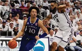  ?? Tony Gutierrez/Associated Press ?? Kansas forward Jalen Wilson (10) works to the basket as TCU’s Eddie Lampkin Jr. defends in the first half on Monday in Fort Worth, Texas.