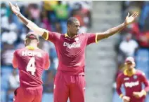  ?? — AFP ?? West Indies’ captain Jason Holder (C) celebrates after dismissing India’s captain Virat Kohli during the fourth ODI at the Sir Vivian Richards Cricket Ground in St John’s, Antigua.