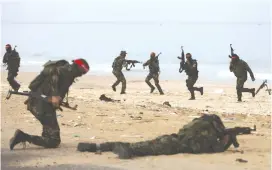  ?? (Ibraheem Abu Mustafa/Reuters) ?? PFLP TERRORISTS drill in Gaza. The university’s decision was taken after students tried to hold a rally marking the 52nd anniversar­y of the PFLP’s founding.