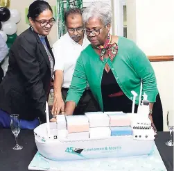  ??  ?? Directors Harry Maragh, Charmaine Maragh (right), and Racquel Maragh cut the 45th anniversar­y cake at the Theme Day celebratio­n.