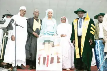  ??  ?? MD NPA, Hadiza Bala Usman holding late Yusufu Bala Usman’s portrait with other guests at the event