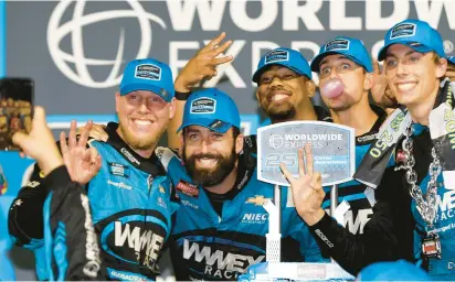  ?? SEAN GARDNER/GETTY ?? Carson Hocevar, driver of the No. 42 Chevrolet, and his crew pose in Victory Lane after the NASCAR Truck Series’ Worldwide Express 250 Saturday night at Richmond Raceway.