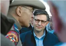  ?? KENNY HOLSTON/THE NEW YORK TIMES ?? House Speaker Mike Johnson confers with law enforcemen­t in Eagle Pass, Texas on Wednesday.