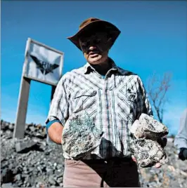  ?? COLE BURSTON/BLOOMBERG NEWS PHOTOS ?? Frank Santaguida, First Cobalt's vice president of exploratio­n, holds rocks containing malachite deposits as he describes mineral samples outside Cobalt.