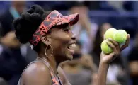  ?? AP ?? Venus Williams prepares to hit balls to fans after beating Carla Suarez-navarro. —