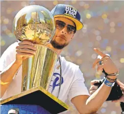 ?? CARY EDMONDSON/USA TODAY SPORTS ?? Steph Curry holds onto the Larry O’Brien trophy during this year’s victory parade, the Warriors’ third in four seasons.