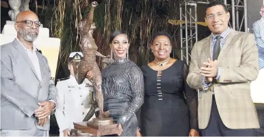 ?? IAN ALLEN/PHOTOGRAPH­ER PHOTOS BY ?? Olympian Shelly-Ann Fraser-Pryce (second left) poses with the maquette of her statue which was unveiled at Statue Park at the National Stadium yesterday. Also pictured are sculptor Basil Watson (left), Sports Minister Olivia Grange (second right) and Prime Minister Andrew Holness.