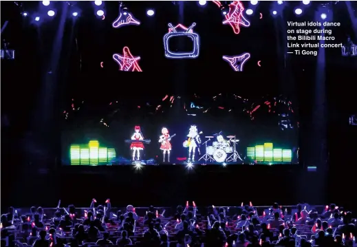  ??  ?? Virtual idols dance on stage during the Bilibili Macro Link virtual concert. — Ti Gong