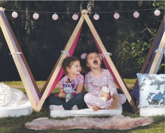  ?? Picture: GLENN HAMPSON ?? Faith Doyle (right) yawns as she and her mate Ava Clark try out some Sleepy Soirees teepees.