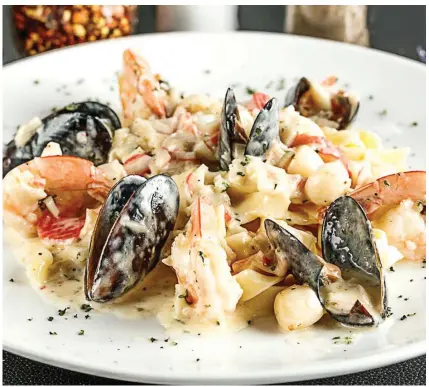  ??  ?? Many of Fratelli’s dishes include fresh seafood and freshly made pasts.