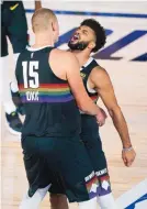  ?? ASHLEY LANDIS/ASSOCIATED PRESS ?? Denver’s Jamal Murray, right, and teammate Nikola Jokic react during the overtime of the Nuggets’ Game 1 victory over utah on Monday in the NBA Playoffs.