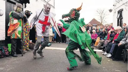  ??  ?? Pub audience enjoying the battle between St George and the dragon - performed by mummers in St Albans