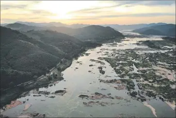  ?? Lillian Suwanrumph­a AFP/Getty Images ?? THE MEKONG RIVER flows through northeaste­rn Thailand in October on its way to Laos, Cambodia, Vietnam and finally the South China Sea. Record low water levels have been blamed on drought and dams.