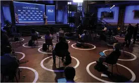  ?? Photograph: Patrick Semansky/AP ?? Reporting in the age of Covid – journalist­s at a press conference with Joe Biden during the US election campaign.