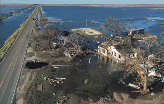  ?? Mario Tama / Getty Images ?? An aerial view of flood waters surroundin­g structures destroyed by Hurricane Laura on Saturday in Creole, La. Hurricane Delta made landfall near Creole as a Category 2 storm in Louisiana, initially leaving some 300,000 customers without power.