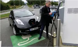  ??  ?? Recharging a Nissan Leaf in Finnøy, an island north of Stavangar in Norway. Photograph: Reuters Staff/Reuters