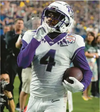  ?? RICK SCUTERI/AP ?? TCU’s Taye Barber quiets the crowd during the Fiesta Bowl against Michigan on Dec. 31 in Glendale, Arizona.