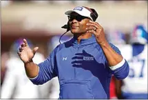  ?? RIGHT: AP FILE PHOTOS ?? Jackson State head coach Deion Sanders points during a game against Louisiana Monroe on Sept. 18 in Monroe, La. Tennessee State head coach Eddie George gestures as his team takes the field during a game against Mississipp­i State on Nov. 20 in Starkville, Miss.