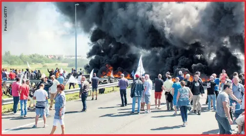  ??  ?? BLAZING MAD: Thick smoke billows into the air as ferry workers set fire to tyres during a strike in Calais yesterday